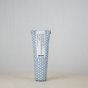 Tube of cream with blue floral pattern on a white background