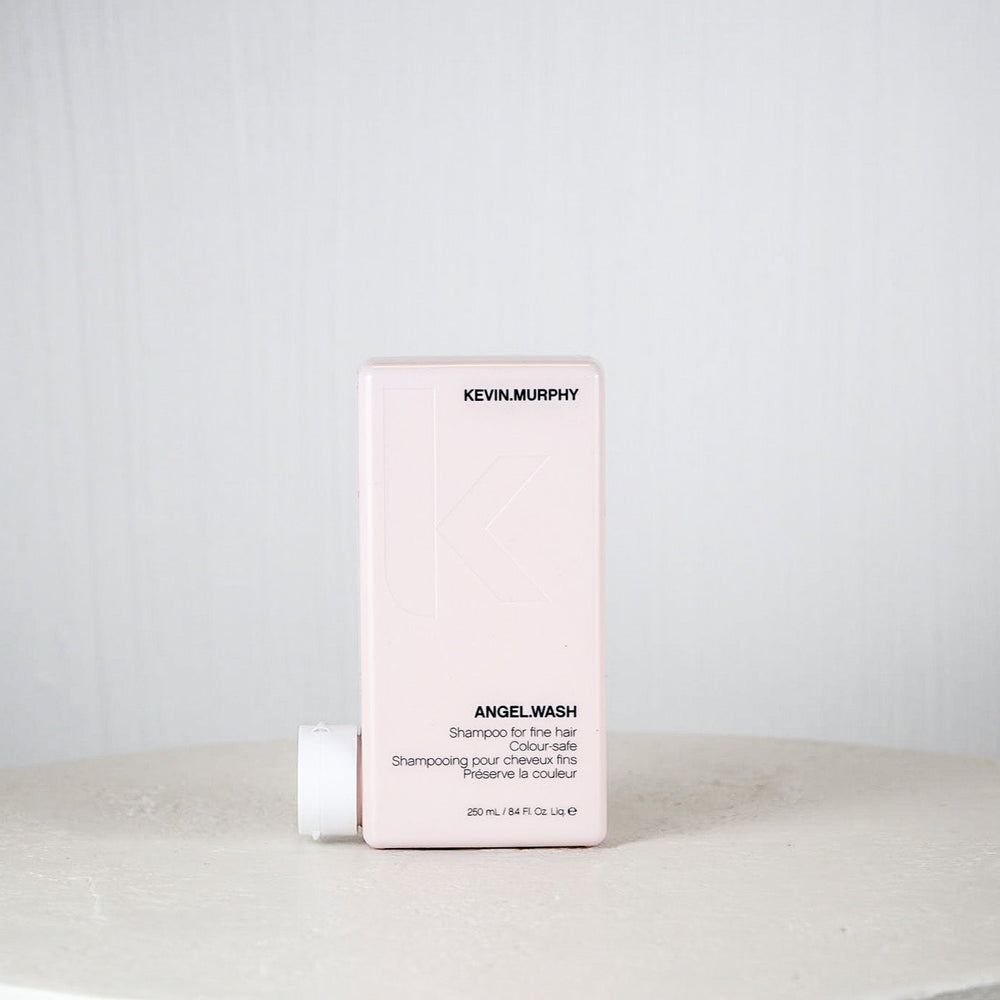 Kevin Murphy shampoo bottle and box on a white surface with a light gray background
