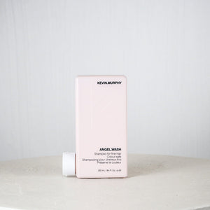 Kevin Murphy shampoo bottle and box on a white surface with a light gray background