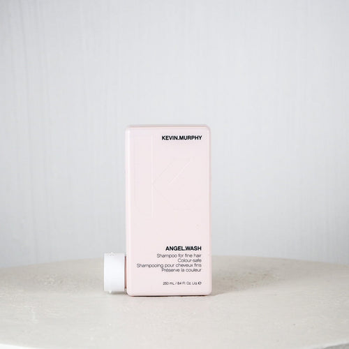 Kevin Murphy shampoo bottle and box on a white surface with a light gray background