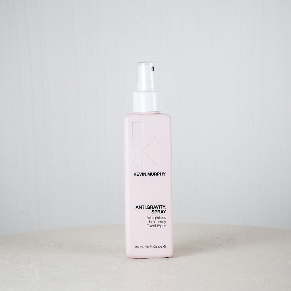 Kevin Murphy hair spray bottle on a white surface with a light gray background