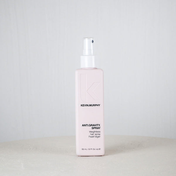 Kevin Murphy hair spray bottle on a white surface with a light gray background