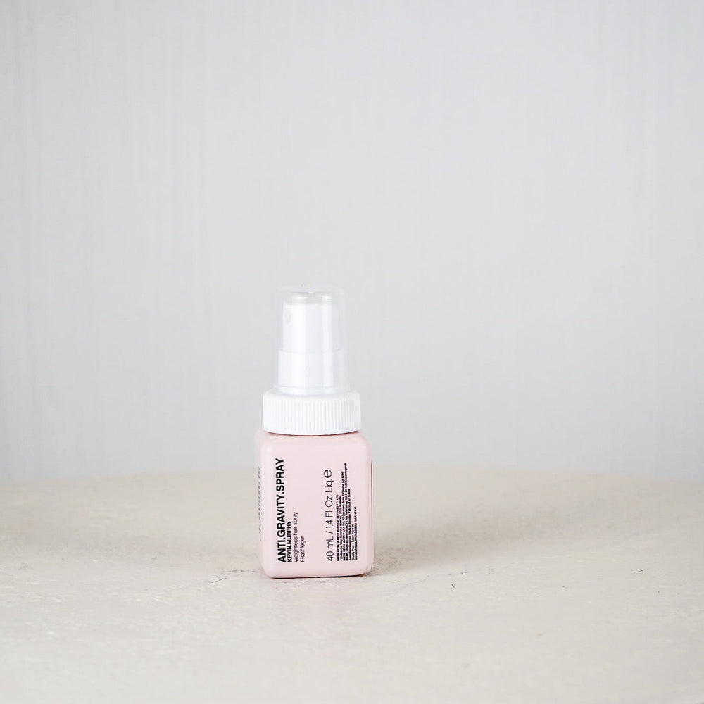 Kevin Murphy hair spray bottle on a white surface with a light gray background