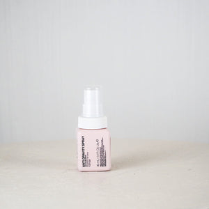 Pink bottle with white cap on a light gray background