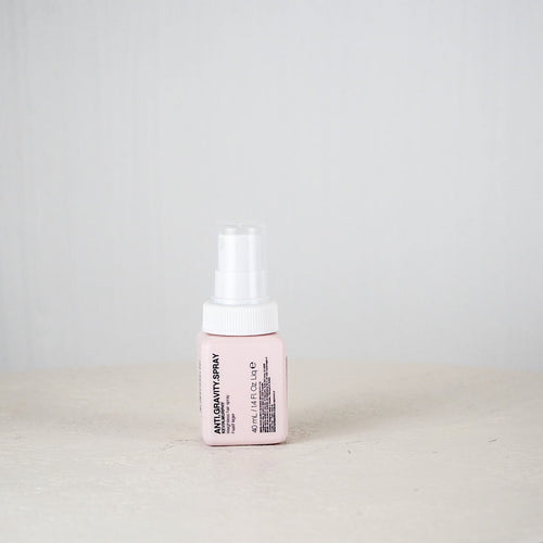 Pink bottle with white cap on a light gray background