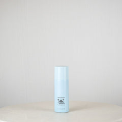 Blue cylindrical container on a white surface with a light gray background