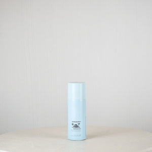 Blue cylindrical container on a white surface with a light gray background