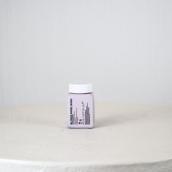 Small white container with a label on a light gray surface and background