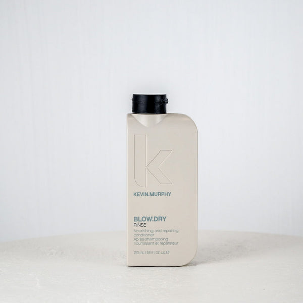 Kevin Murphy hair product bottle on a white surface with a white background