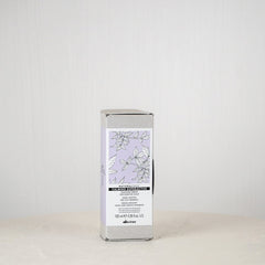 Skincare product packaging on a white surface with a light gray background
