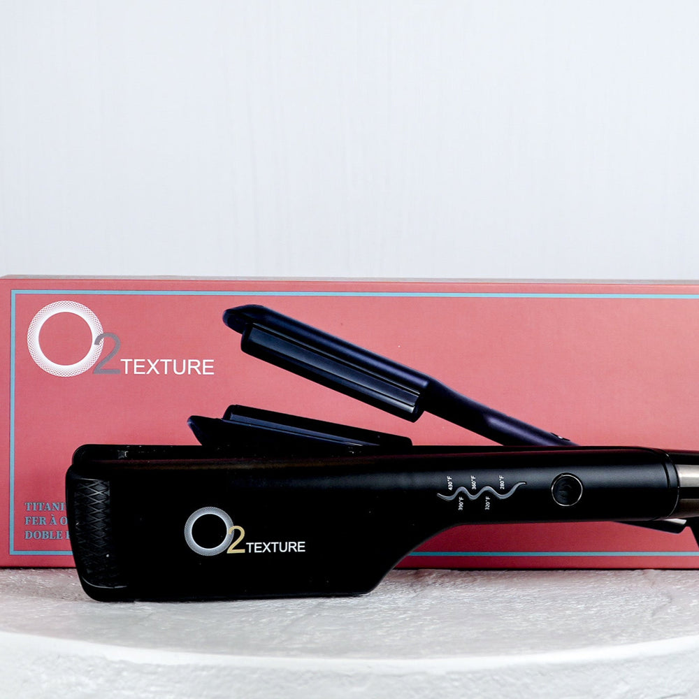 Black hair straightener on a white surface with a light gray background