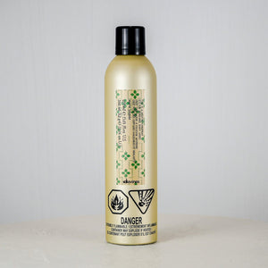 Bottle of shampoo with a label on a white surface and light gray background