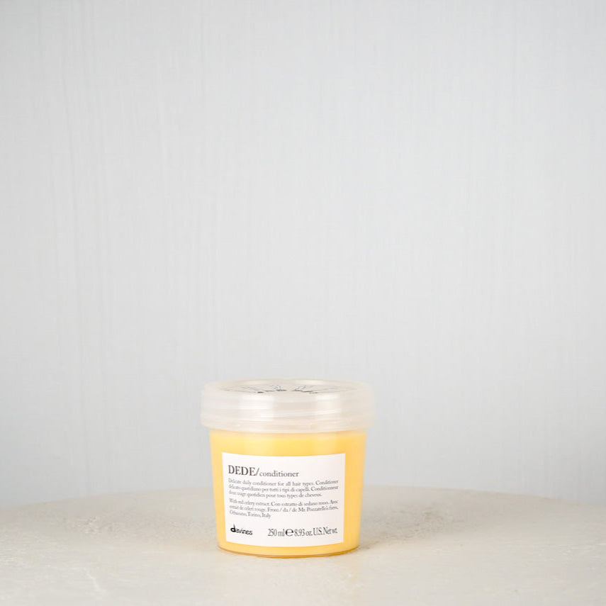 Davines DEDE conditioner bottle on a light gray background