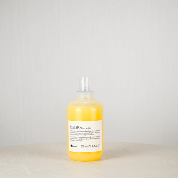 Bottle of Davines DEIDE hair care product on a white surface with a gray background