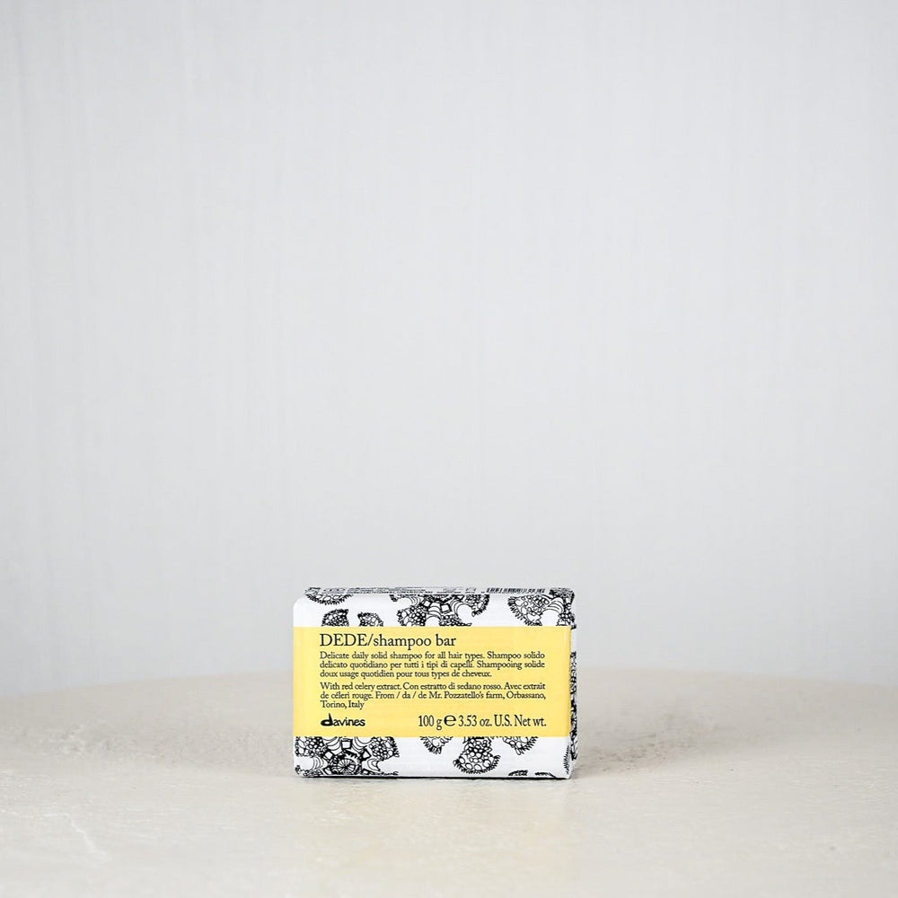 Bar of soap with a yellow label on a white surface