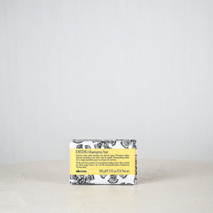 Bar of soap with a yellow label on a white surface