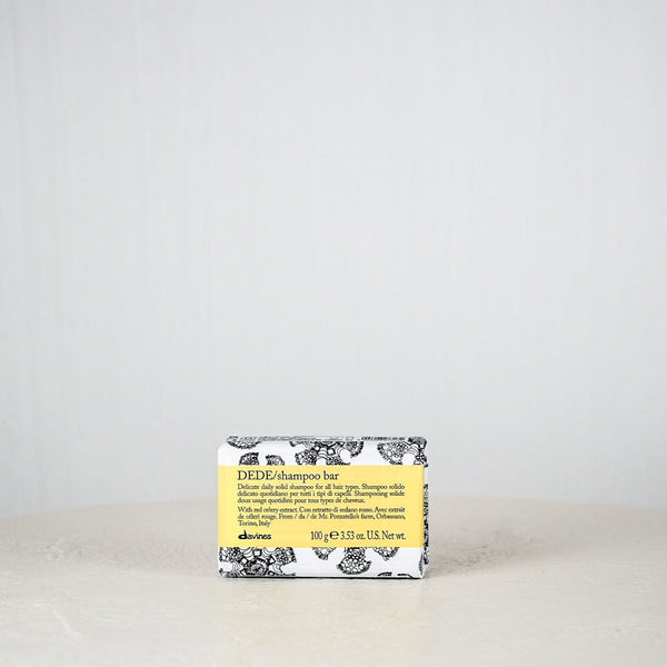 Bar of soap with a yellow label on a white surface