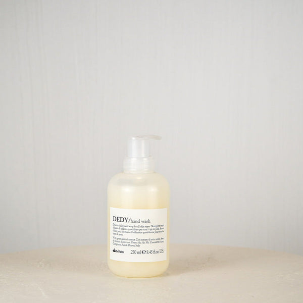 Bottle of DEDY hand wash on a neutral background