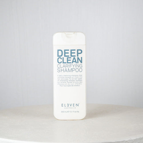 Shampoo bottle labeled 'Deep Clean Clarifying Shampoo' by 'Eleven' on a white surface with a light gray background