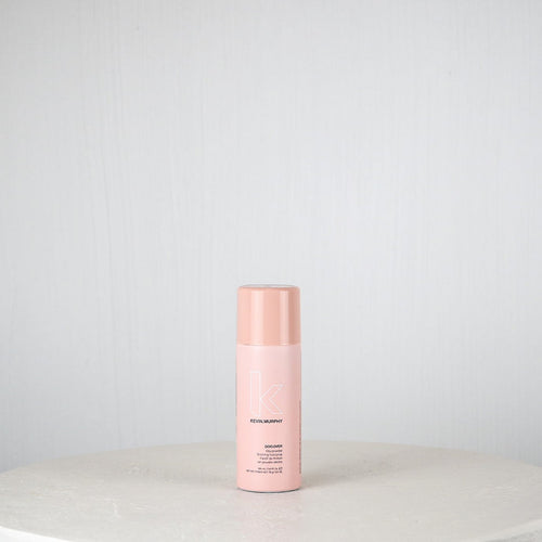 Pink bottle on a white surface with a light gray background