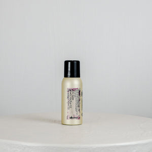 Small bottle with a black cap on a light gray background