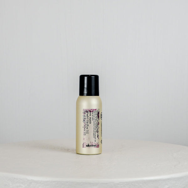 Small bottle with a black cap on a light gray background