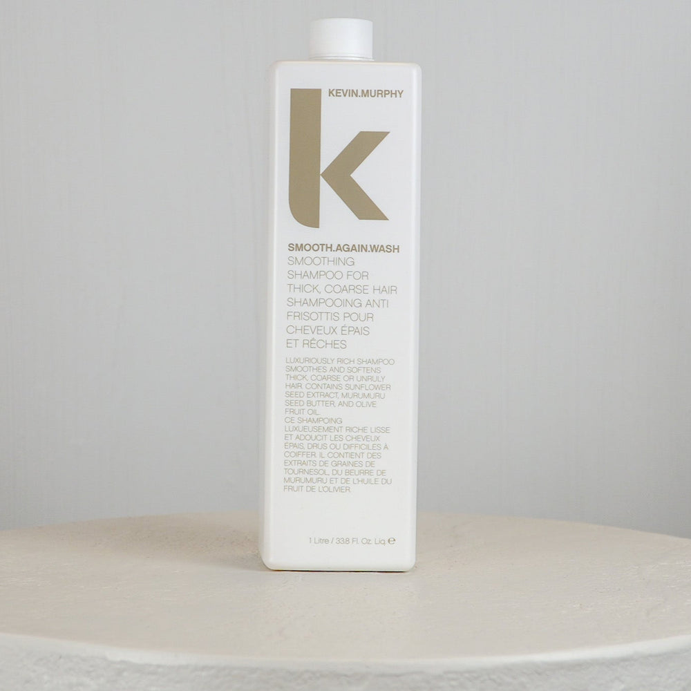 Kevin Murphy shampoo bottle on a white surface with a gray background