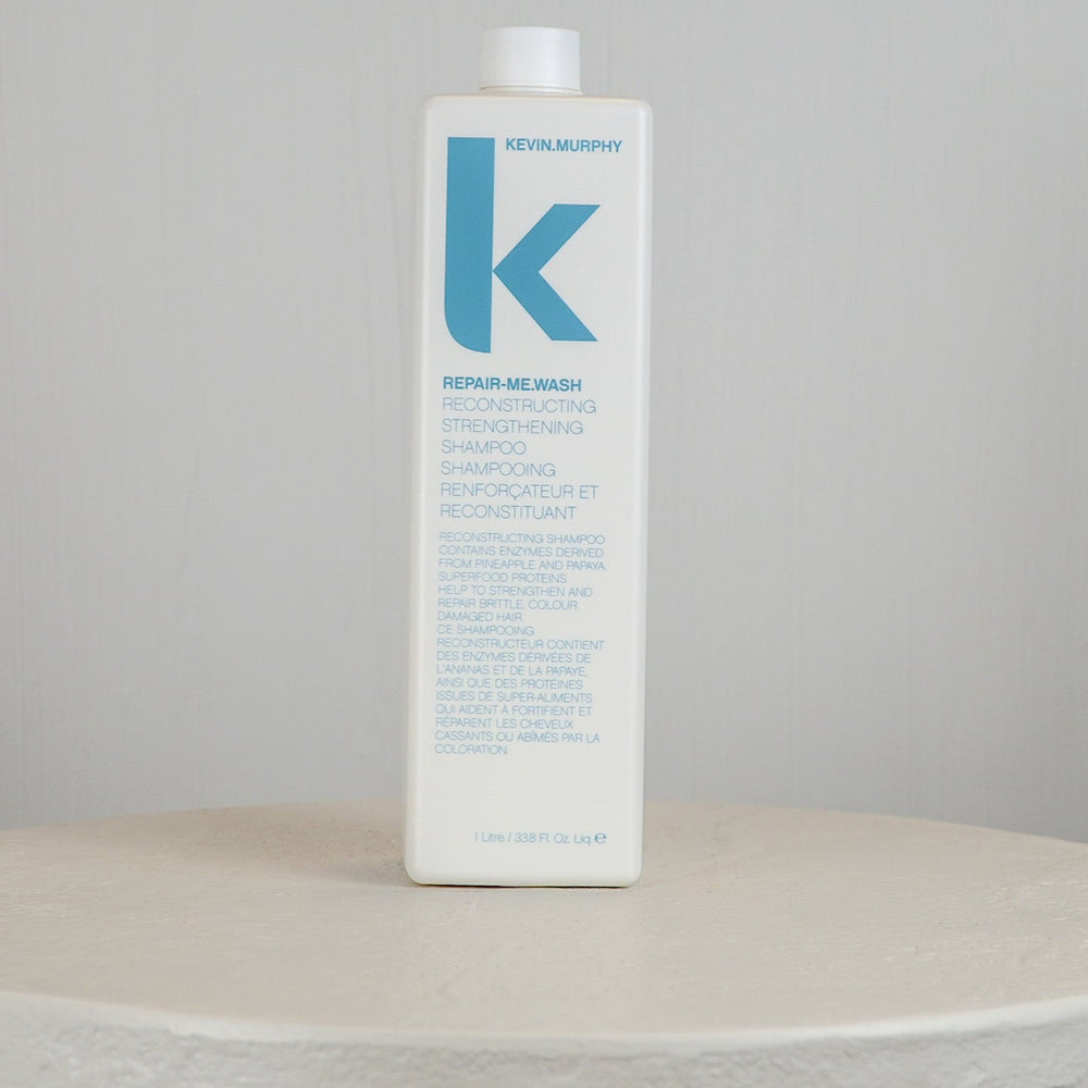 Blue bottle with white cap on a white surface against a light gray background