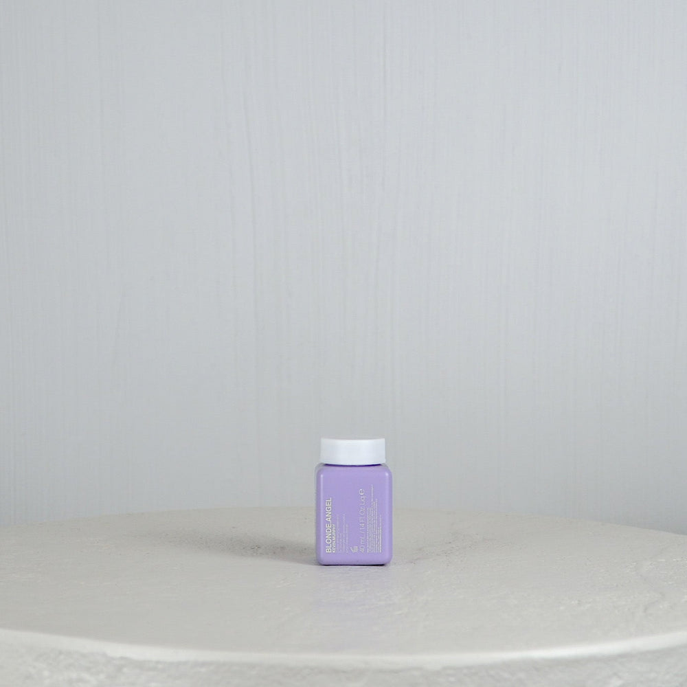 Purple container with a brand logo on a white surface and light gray background