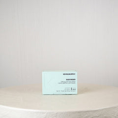 Business card on a round stone surface with a plain background