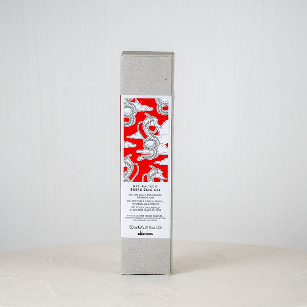 Skincare product box with red and white design on a white surface and background