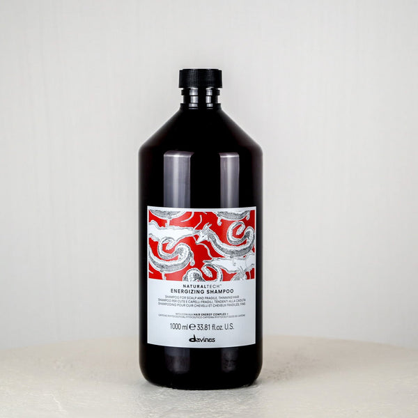 Bottle of shampoo with a decorative label on a white surface