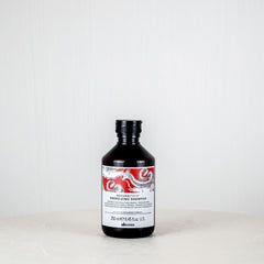 Bottle of Dầuit shampoo on a white background