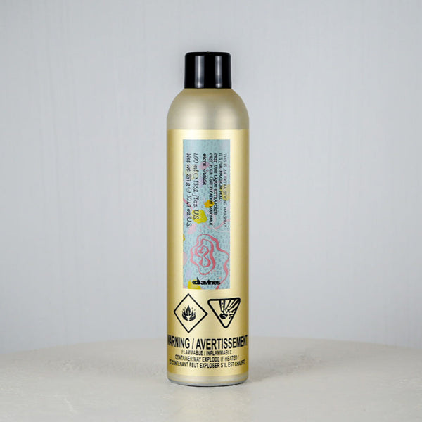 Gold bottle with a label on a gray background