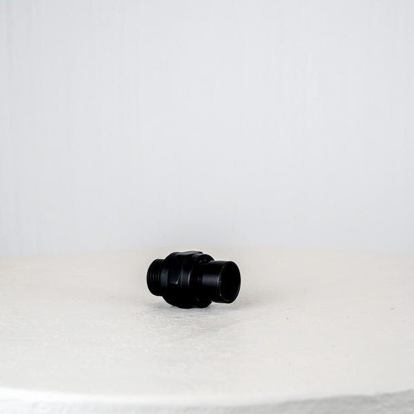 Black plastic fitting on a white background