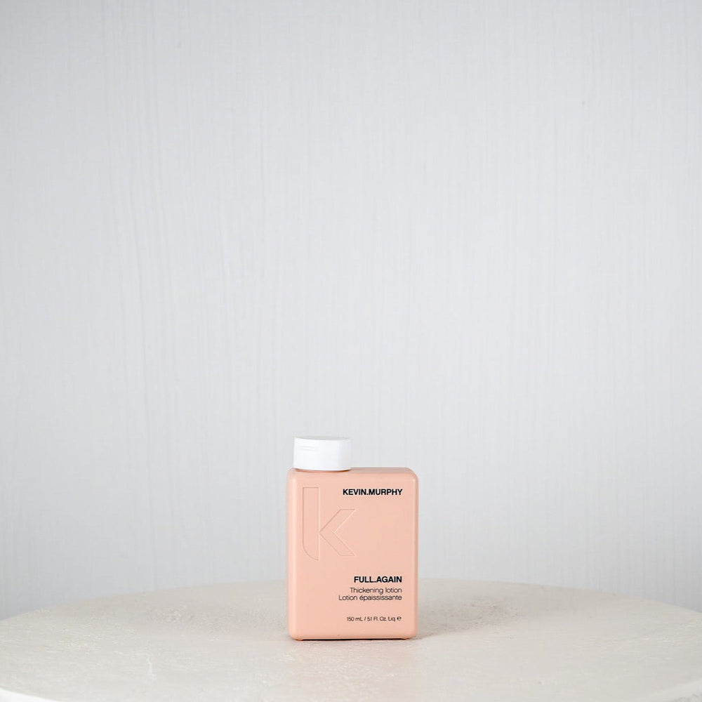 Pink bottle labeled 'Kemon' on a white surface with a light gray background