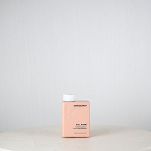 Pink bottle labeled 'Kemon' on a white surface with a light gray background