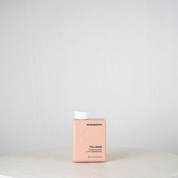 Pink bottle labeled 'Kemon' on a white surface with a light gray background