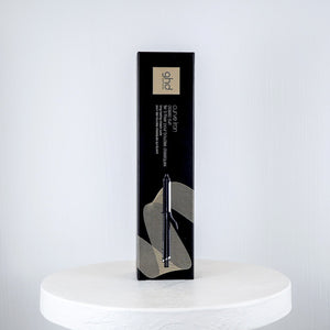 ghd curling iron packaging on a white surface with a white background