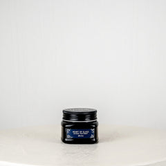 Black jar with a lid on a white background