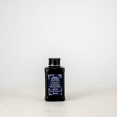 Black bottle with a label on a white background