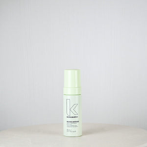 Bottle of Kevin Murphy product on a white surface with a light gray background