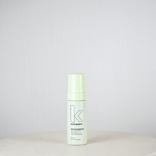 Bottle of Kevin Murphy product on a white surface with a light gray background