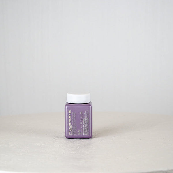 Purple container with white cap on a white surface and light gray background