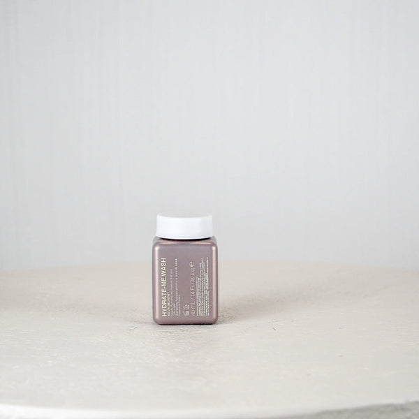 Small rectangular container with a white cap on a light gray surface and background