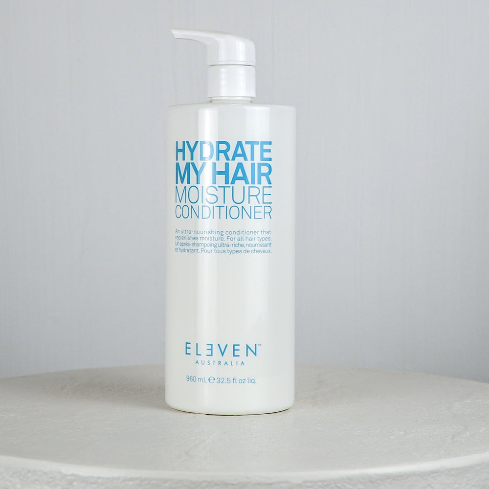 Bottle of 'Hydrate My Hair Moisture Conditioner' by Eleven on a neutral background
