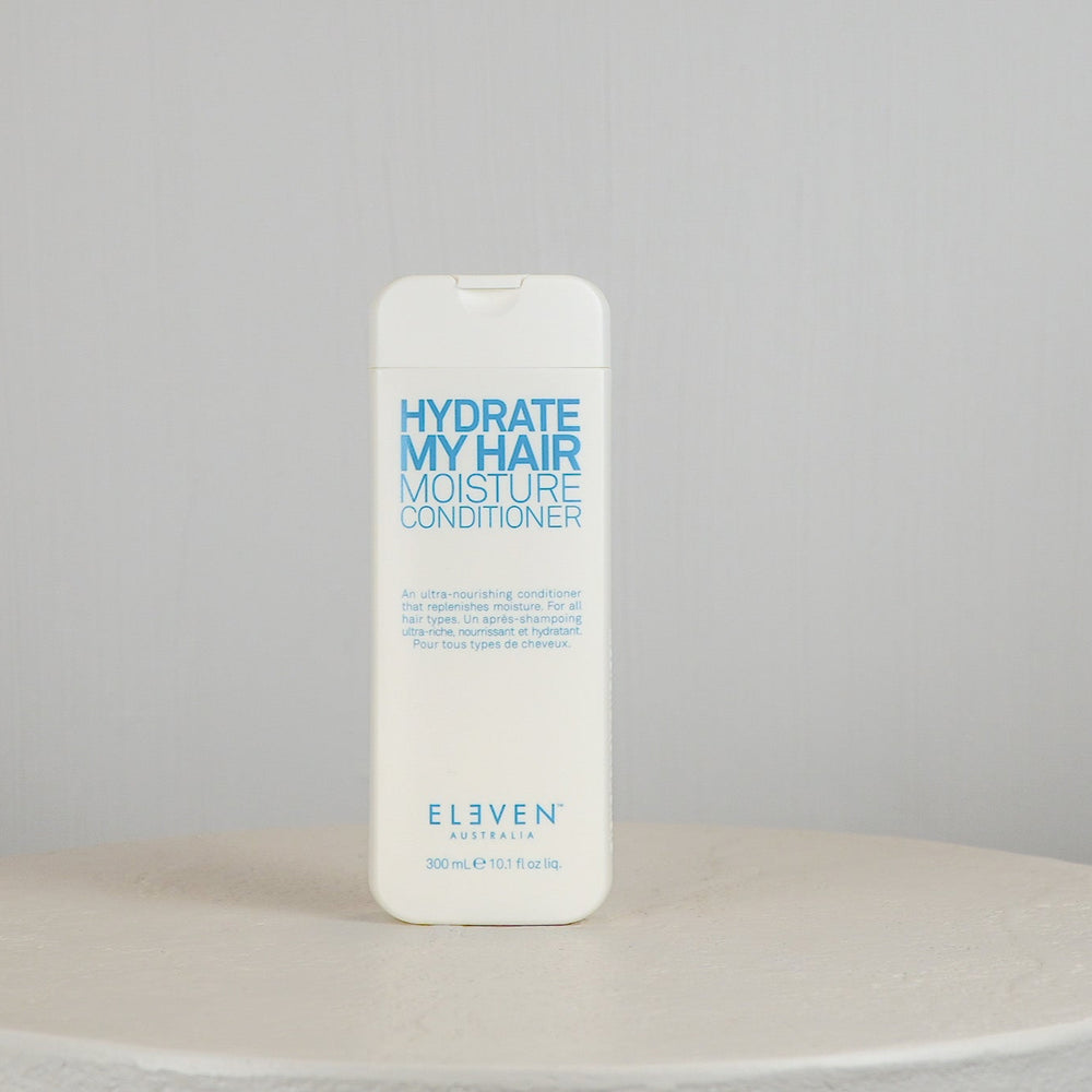 Bottle of 'Hydrate My Hair Moisture Conditioner' by Eleven on a neutral background