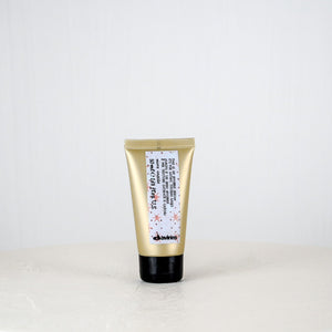 Gold tube of skincare product on a white background