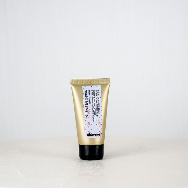Gold tube of skincare product on a white background