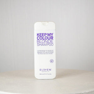 Shampoo bottle labeled 'Keep My Colour Blonde Shampoo' by Eleven Australia on a white surface with a gray background.